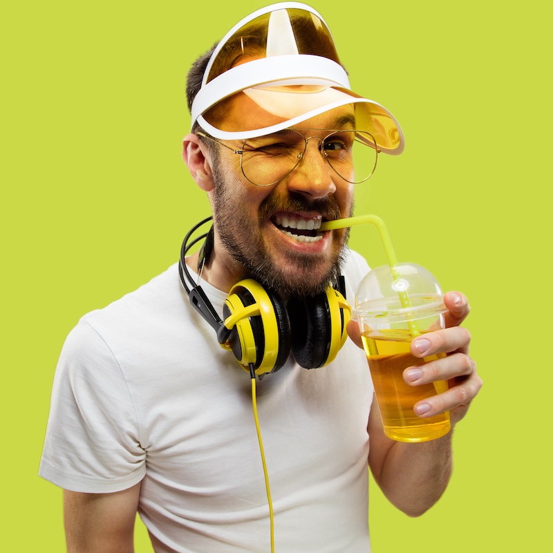 Half-length close up portrait of young man on yellow background